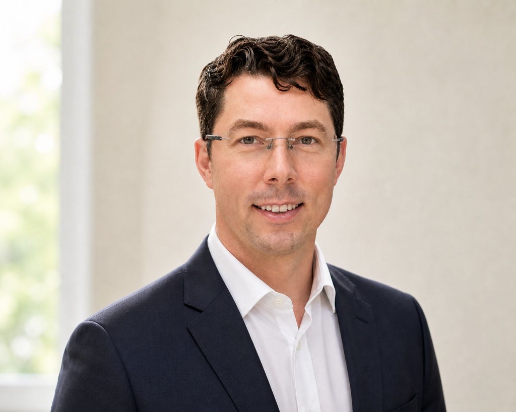 Professional headshot of Liam, Co-founder at The Reading Fox, wearing a navy blazer and white shirt